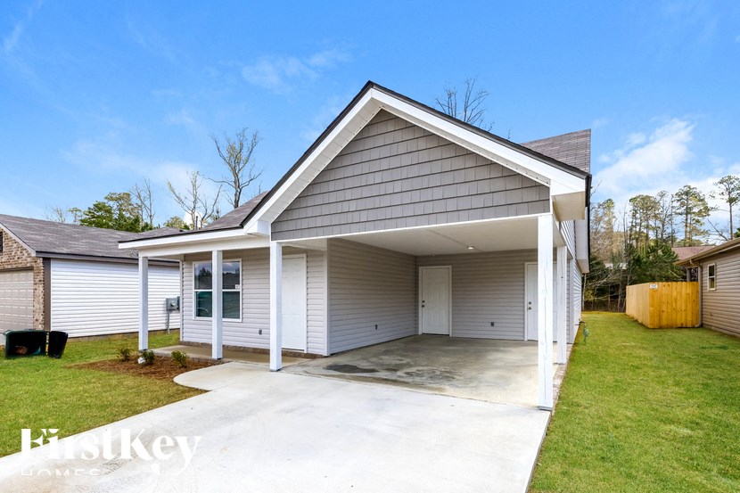 A garage with a white door is attached to a house.