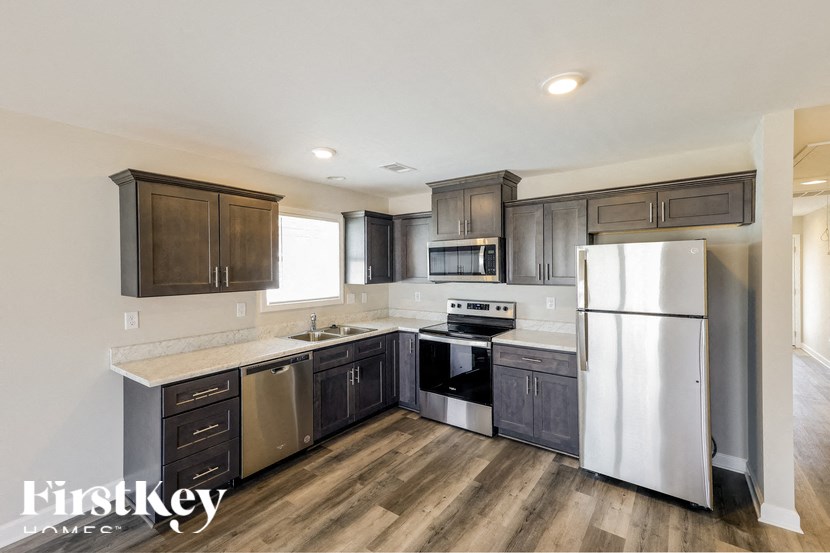 A kitchen with wooden cabinets and stainless steel appliances.