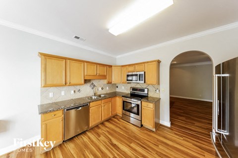 A kitchen with wooden cabinets and stainless steel appliances.