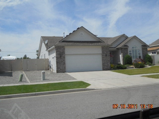 a house with a white garage door on a driveway