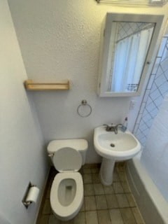 a bathroom with a toilet and a sink
