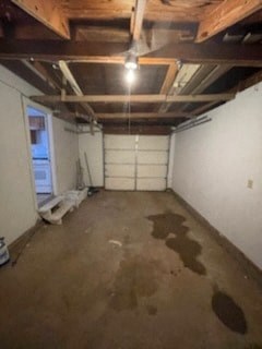 a basement room with water stains on the floor and a window