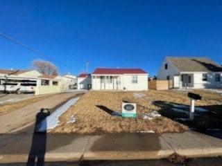 a street with houses and a yard with an electric meter