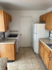 a kitchen with wooden cabinets and a white refrigerator