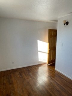an empty living room with white walls and wooden floors
