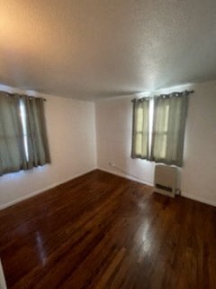 a living room with a wood floor and curtains