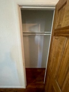 an empty closet in a room with a wooden door