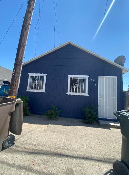 a blue house with two windows and a white door