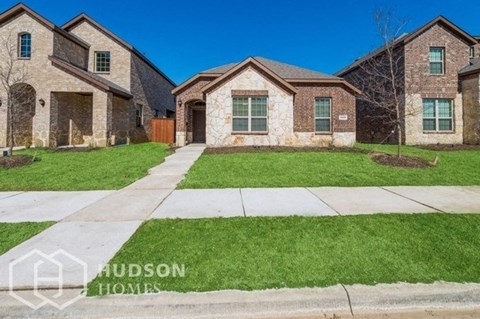 a house with a lawn and a sidewalk in front of it