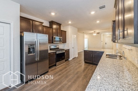 a modern kitchen with stainless steel appliances and granite counter tops