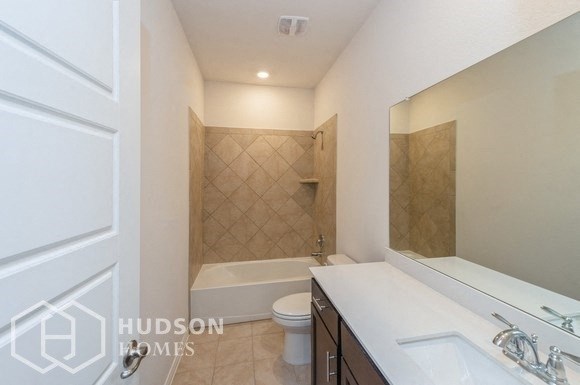 a bathroom with a sink and a toilet and a bath tub