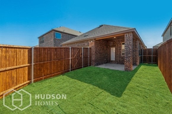 a fenced in backyard with a yard and a fence