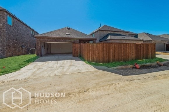 a house with a driveway and a wooden fence