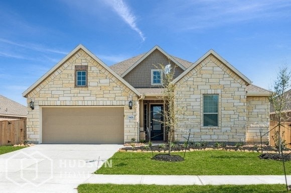a house with a driveway and a garage door in front of it