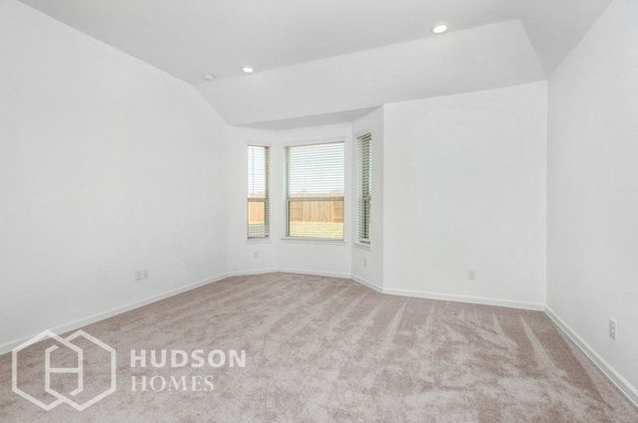 an empty living room with white walls and a window