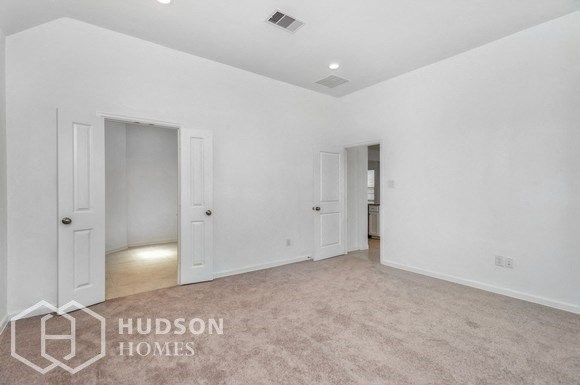an empty living room with white walls and white doors