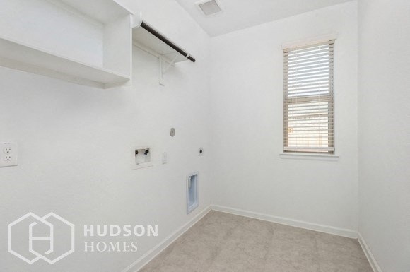 an empty room with white walls and a window