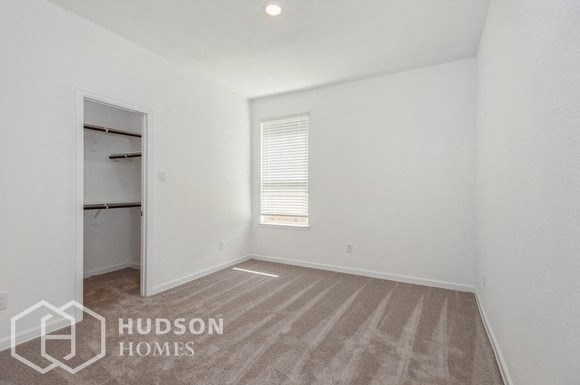 an empty room with a closet and a window