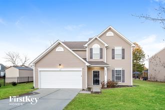 a beige house with a white garage door