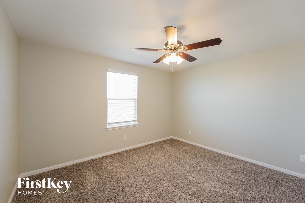 A room with a fan and a window.