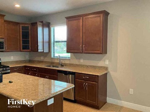 a kitchen with wooden cabinets and granite counter tops