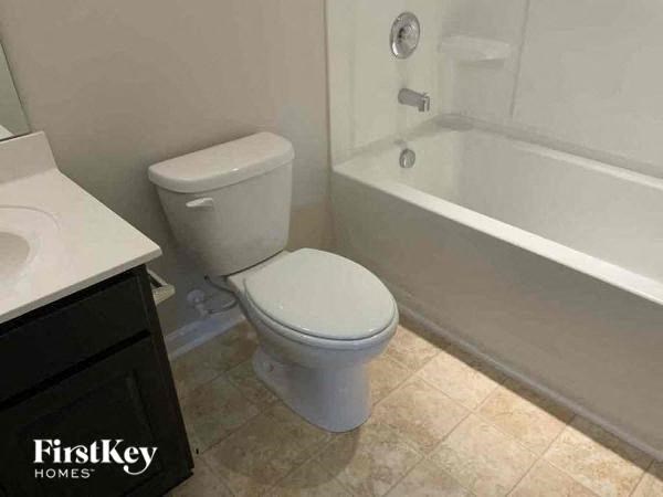 a bathroom with a toilet and a bath tub