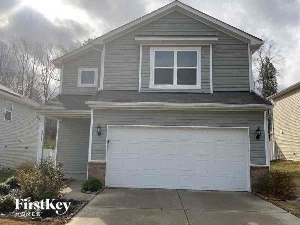 a gray house with a white garage door