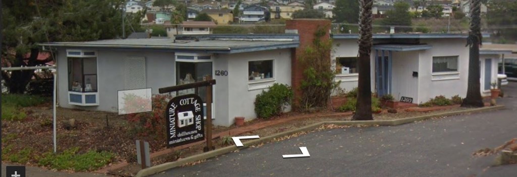 a white building with a sign in front of it