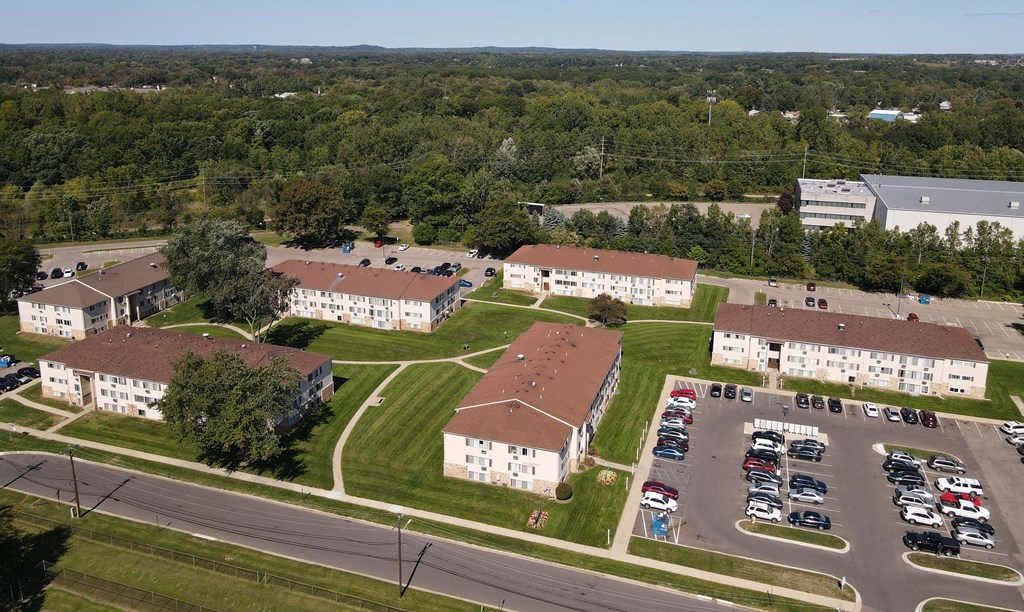 an aerial view of a campus with several buildings and a parking lot