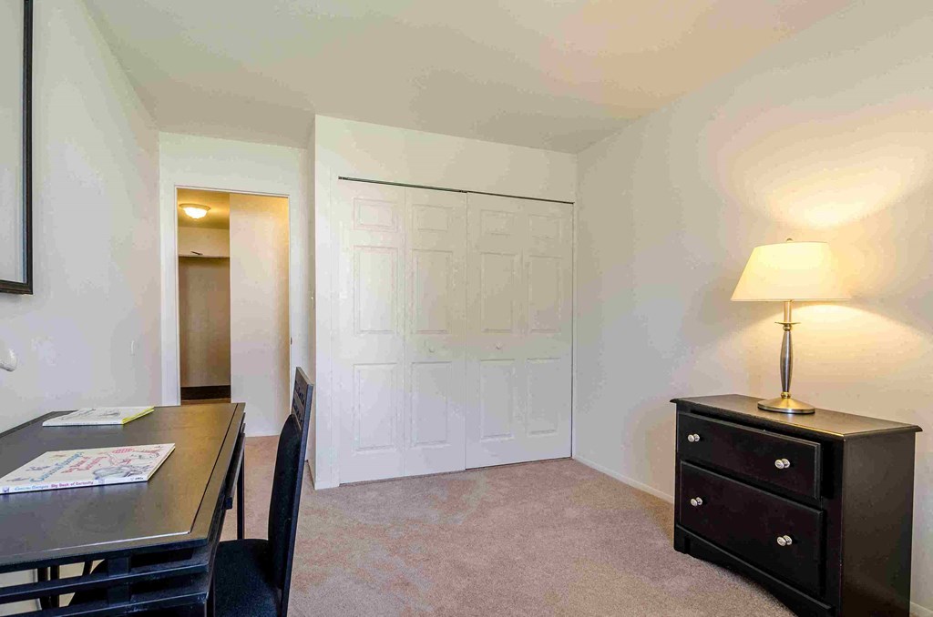 a room with a desk and a chair and a table