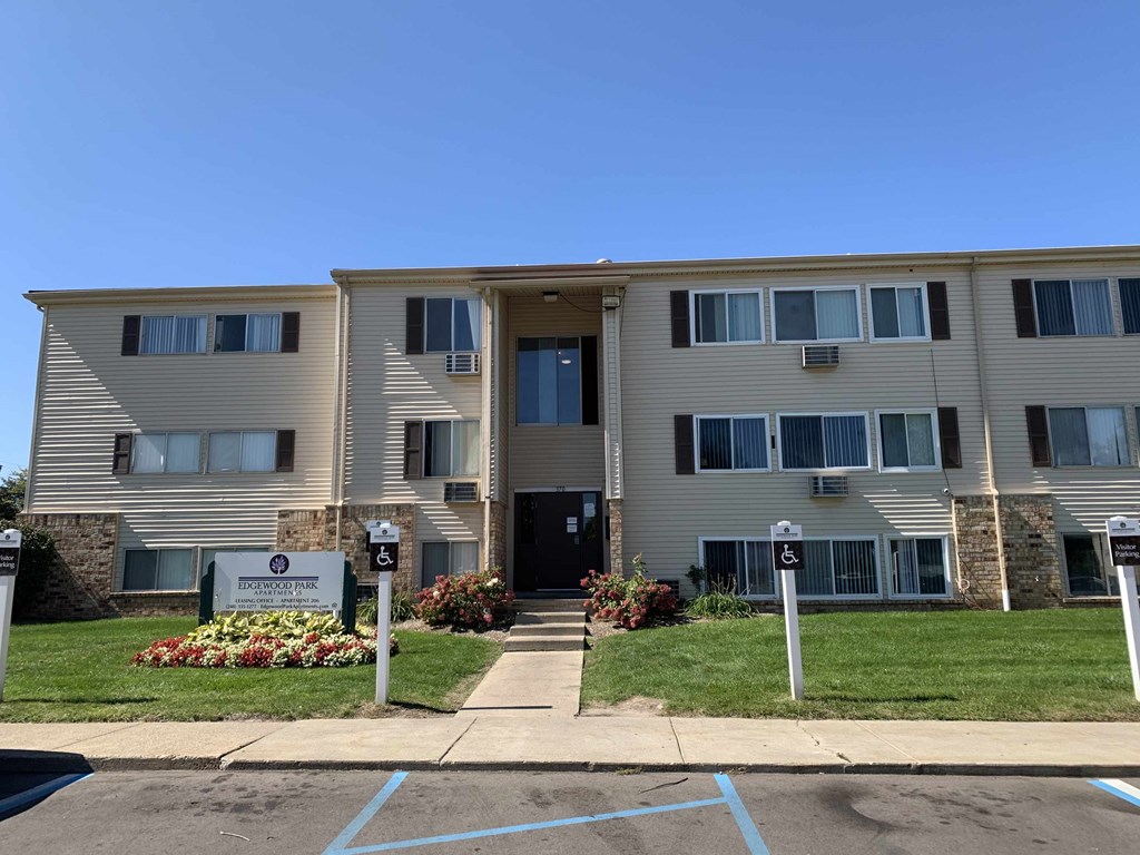 an apartment building with parking meters in front of it