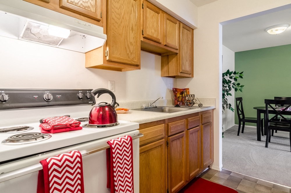 a kitchen with a stove top oven and a sink