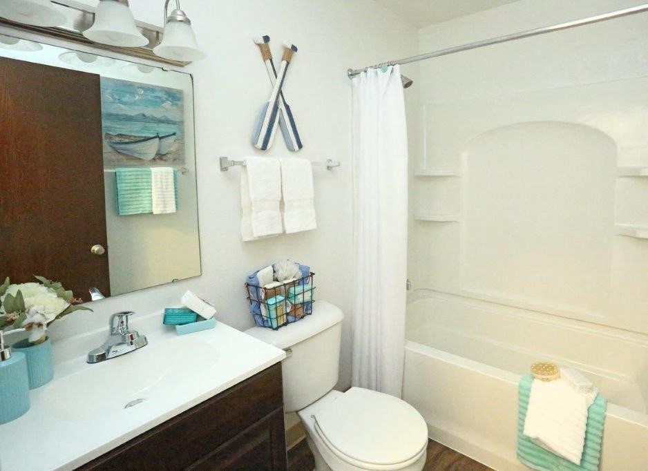 a bathroom with a toilet and a sink and a shower