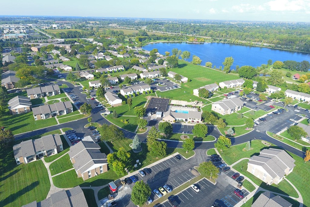 an aerial view of a neighborhood of houses and a lake