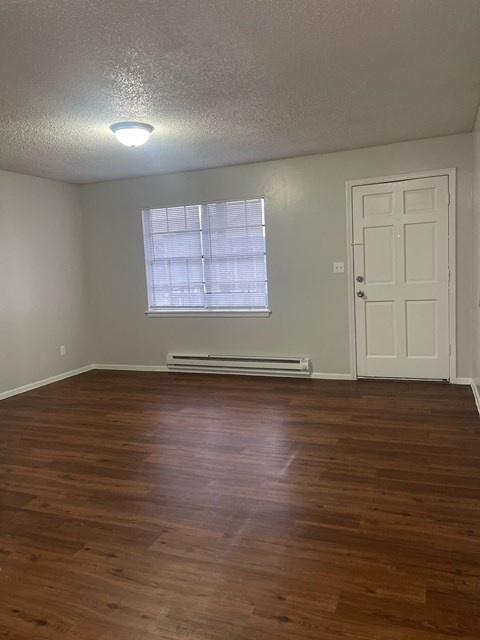 A room with a window and a door.