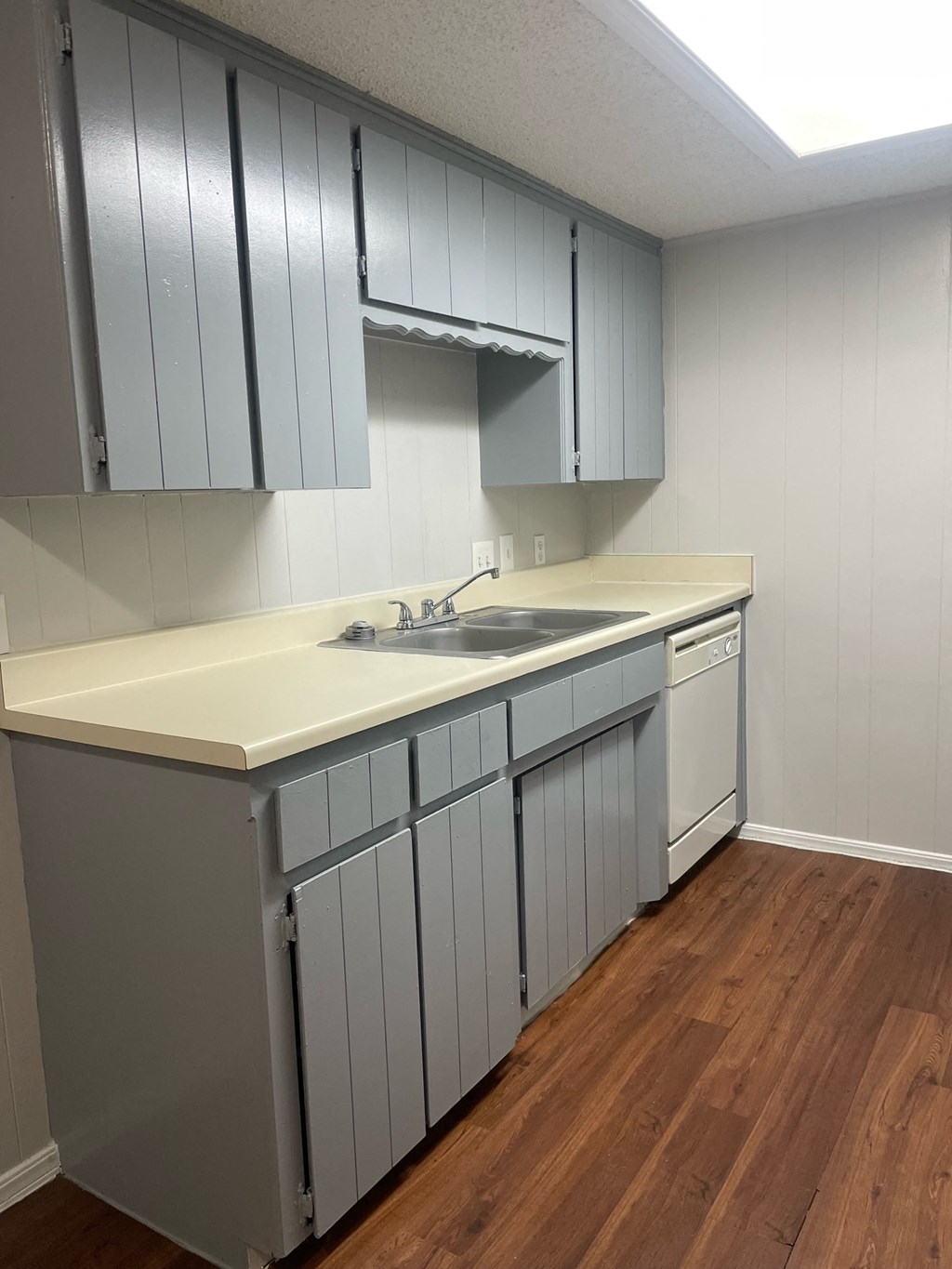A kitchen with a sink and cabinets.