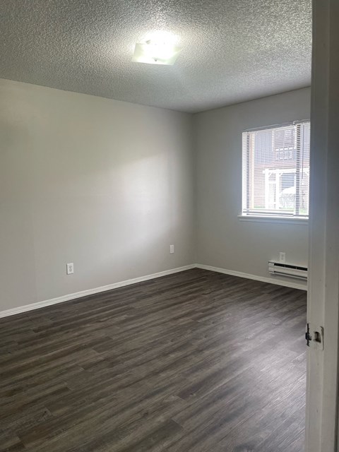 A room with a window and a door.