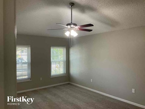 a bedroom with a ceiling fan and a window