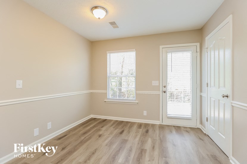 A room with a wooden floor and white walls.