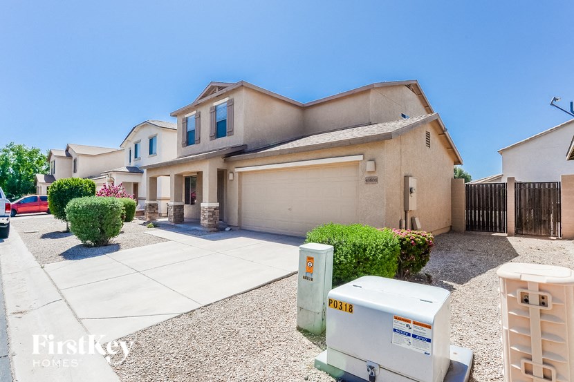 a house with a driveway and a fridge in front of it