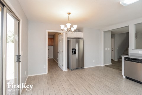 a renovated kitchen and living room with a stainless steel refrigerator