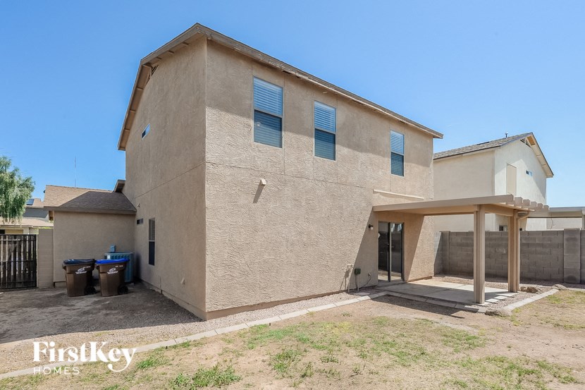 the front of a brick house with a covered porch