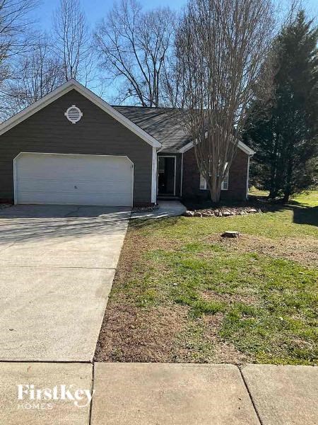 a house with a white garage door on a driveway