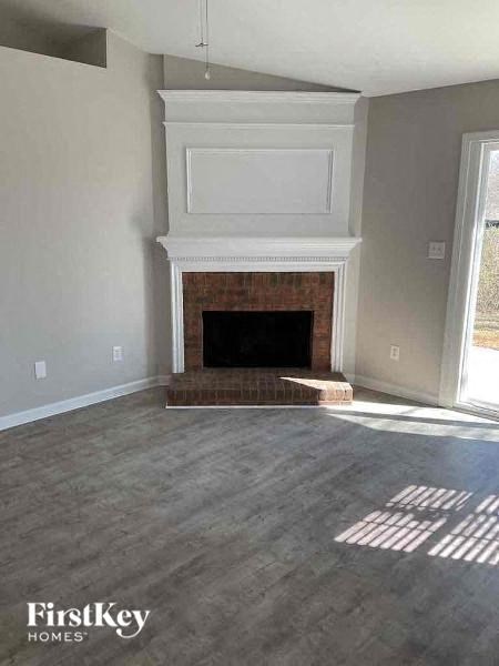 a living room with a fireplace and a window