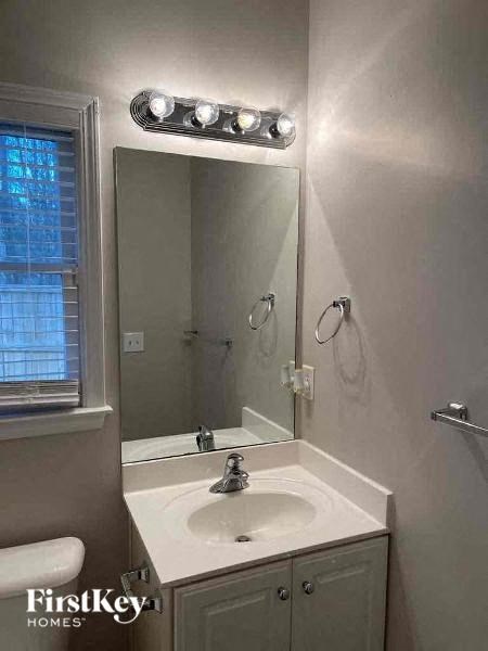 a bathroom with a white sink and a mirror