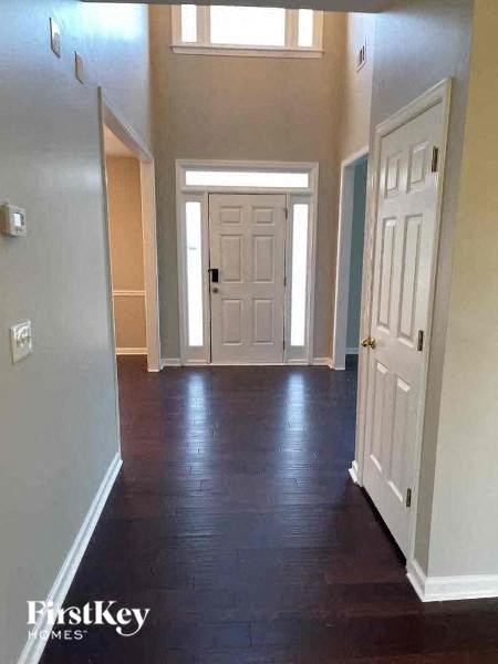 an empty hallway with a white door and