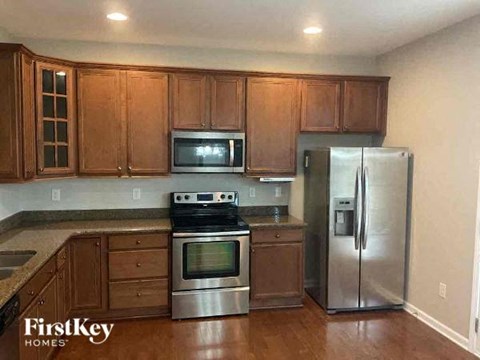 a kitchen with stainless steel appliances and wooden cabinets