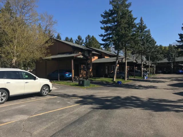 a parking lot in front of a building with a car parked