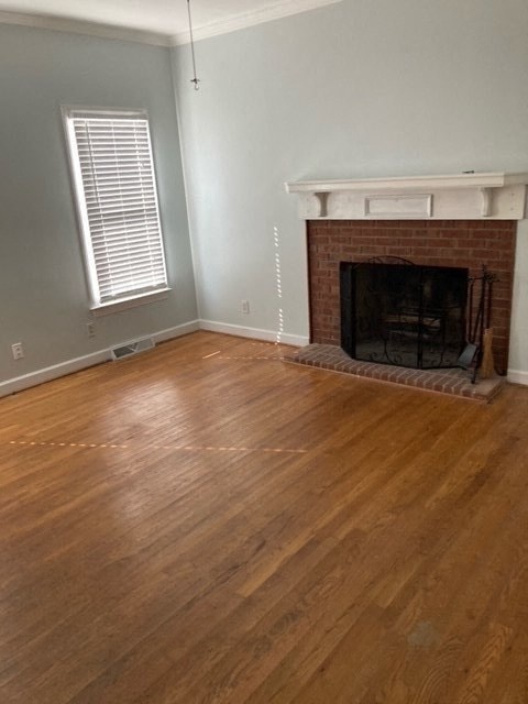 a living room with a fireplace and a wooden floor