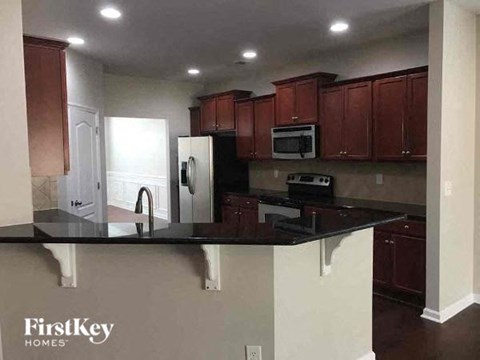 a kitchen with a black counter top